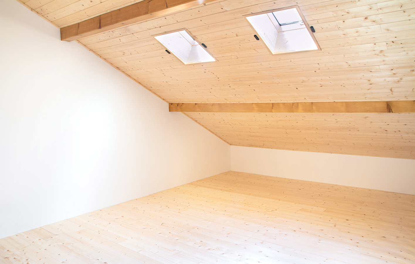 Zimmer mit Dachschräge aus Holzpaneelen